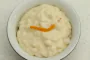 Arroz con leche con ralladura y zumo de naranja, aligerado con nata montada.